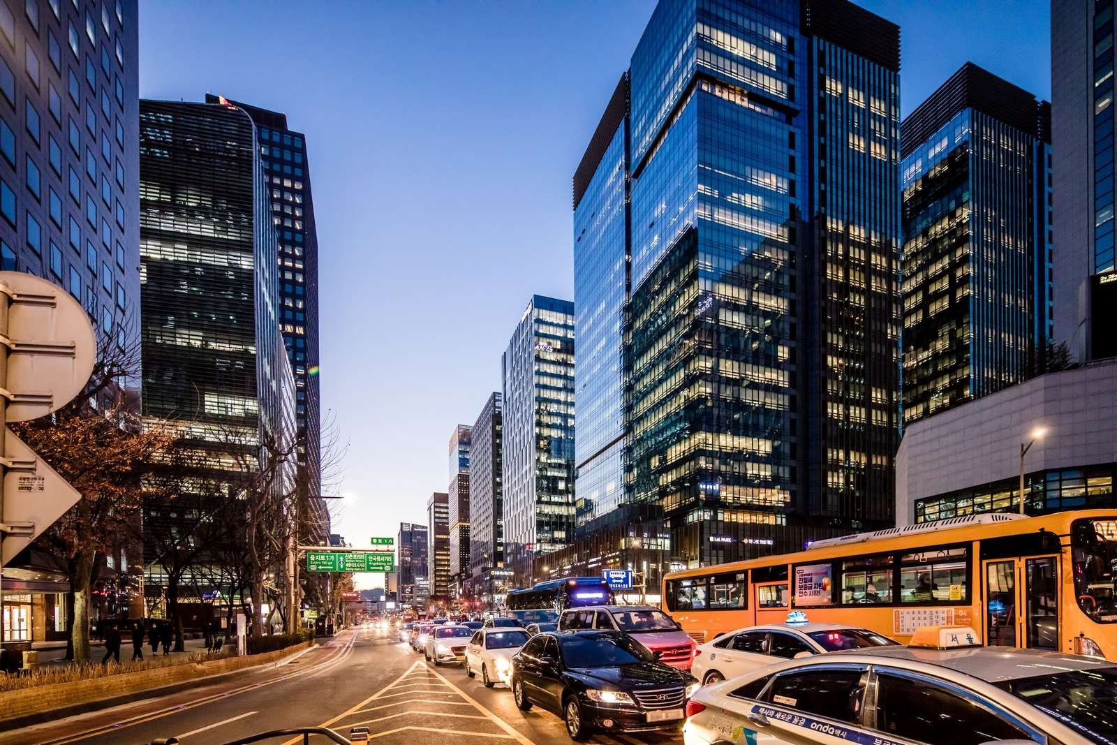 Jongno Street in downtown Seoul at night with traffic and city lights